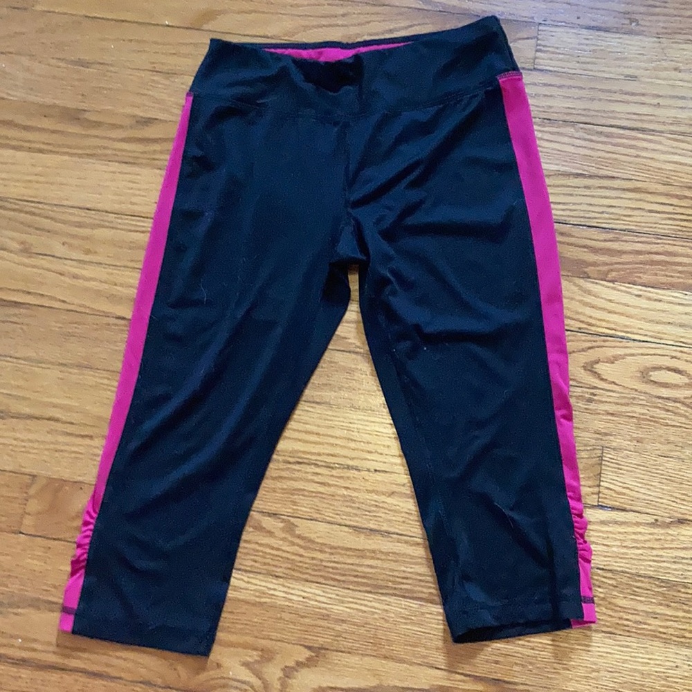 Black exercise pants with a pink 3/4 length
